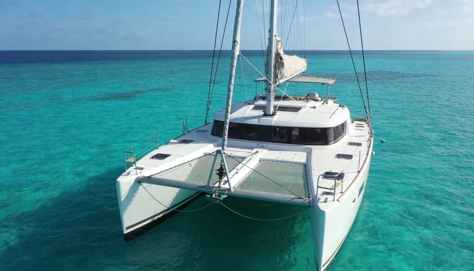 Catamaran price: catamaran sailing on turquoise sea